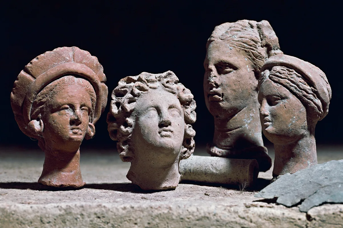 Four head sculptures of women, sourced from a Roman temple, made of terracotta