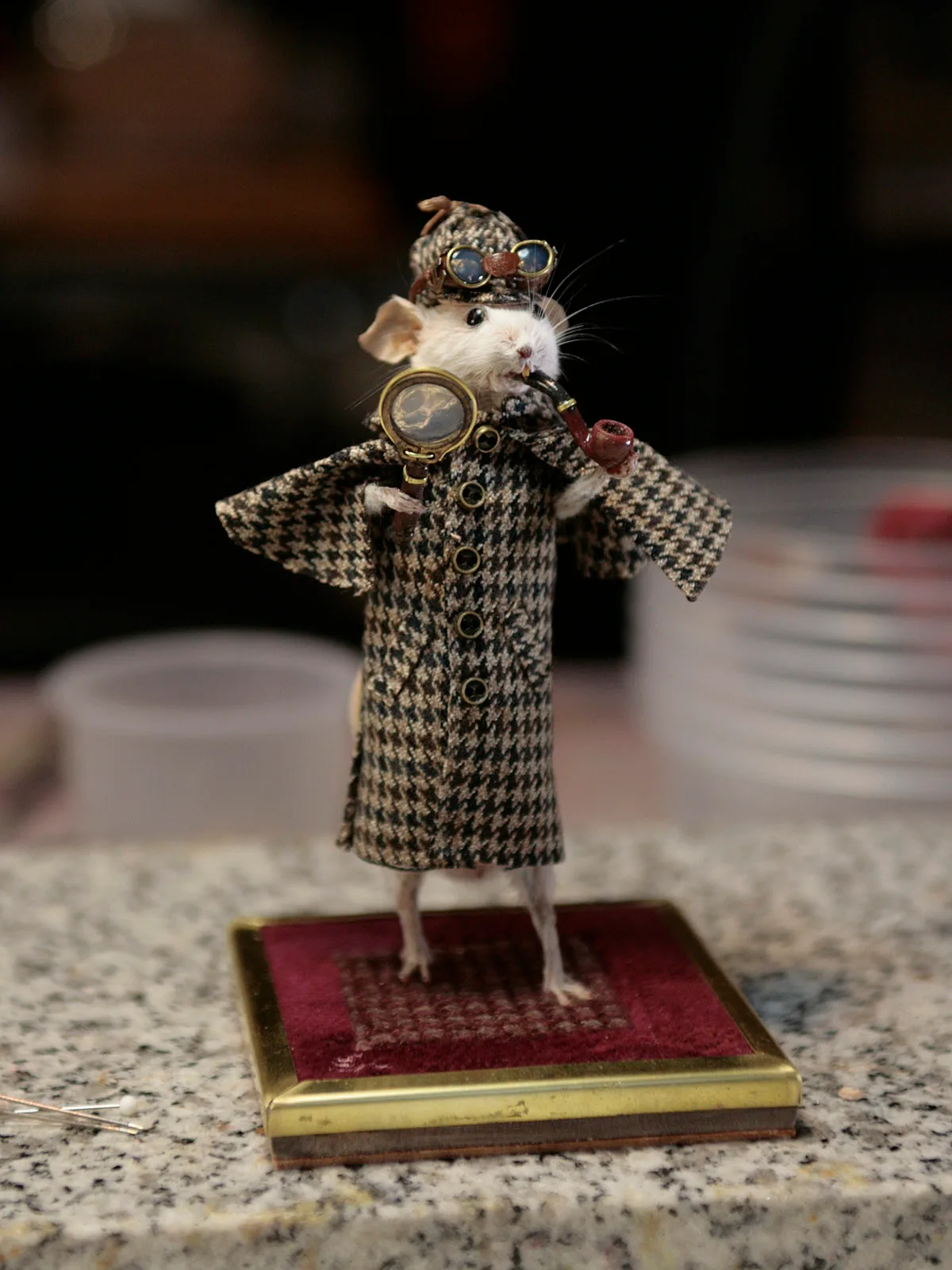 Taxidermy mouse figure, dressed as Sherlock Holmes, with herringbone coat, magnifying glass, pipe and hat